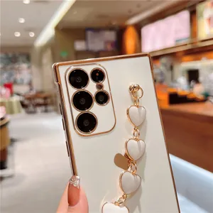 Detail view of electroplated white Samsung phone case with elegant heart chain strap and soft TPU.