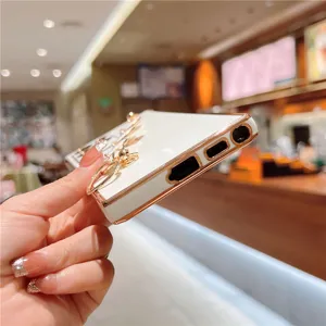 White rose gold electroplated phone case with bracelet charm detail, precision cutouts.