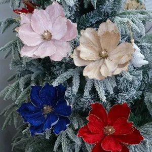 Detailed view of velvet Christmas flowers with gold trim for tree and holiday decor.