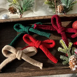 Detailed close-up view of colorful knitted bows arranged nicely on a festive wooden tray.