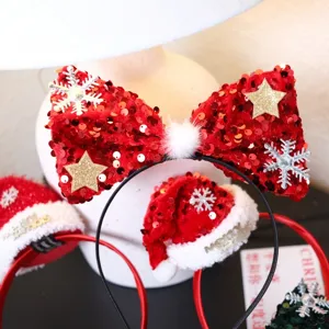 Close up detail of Christmas sequin bow and mini Santa hat headband with festive decorations.