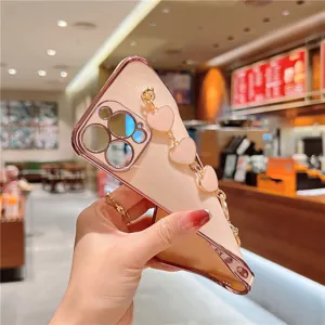 Close-up of pink electroplated phone case with a luxury gold heart chain strap.