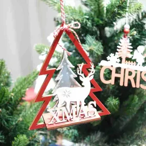 Close-up detail shot of red wooden Christmas tree hanging ornament with deer and XMAS text.