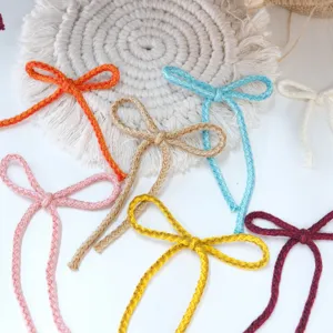 Close-up detail shot of colorful braided cotton rope bows, perfect for Christmas tree decor.