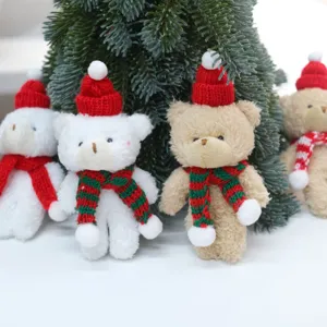Detailed view of cute Christmas plush bear hanging ornaments with red hats and scarves.