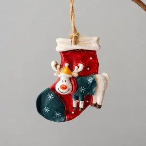 Detailed view of resin Christmas boot pendant with cute reindeer, ideal holiday tree decor.