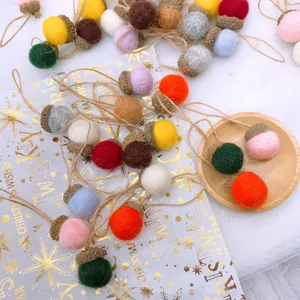 Colorful felt wool acorn decorations with twine string for Christmas DIY hanging crafts and party decor.
