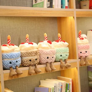 Cute plush cake toy with candle and dangling legs, soft stuffed doll for home decor.