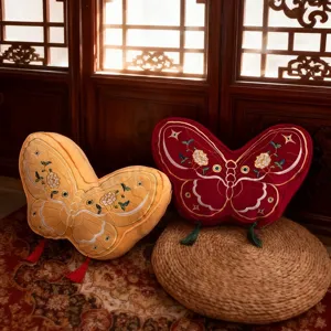 Cute butterfly shaped plush throw pillow with delicate embroidery and tassels for home sofa.