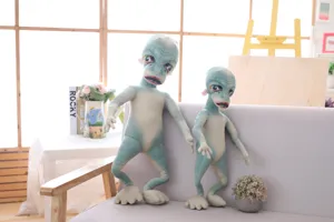 Detailed view of funny alien plush doll, ugly cute stuffed toy pillow with unique weird design.