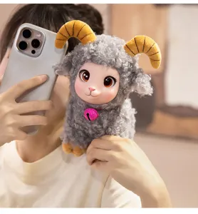 Detailed view of cute vinyl face plush sheep bag pendant with curly wool and bell decoration.