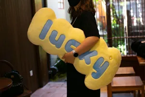 Large yellow plush lucky letter body pillow, soft couch cushion and comfortable sleeping companion.