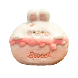 Cute cartoon cake plush pillow with bunny face and warm hand design, soft and sweet winter gift.