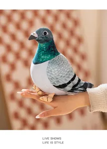 Close-up of a realistic pigeon plush toy held on hand, showcasing detailed feathers and cute beak.