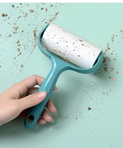 Lint roller detail view showing sticky paper cleaning debris from surfaces efficiently.