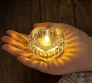 Detailed macro view of a heart-shaped ribbed glass candle holder with warm light effect