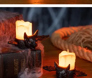 Decorative Halloween bat shaped flickering LED candle lights with spider web props on table