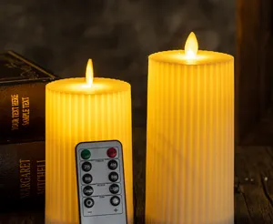 Detailed view of ribbed LED pillar candles with warm amber glow and multi-function remote control