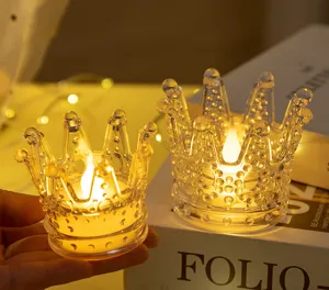 Detailed macro view of a warm LED crown electronic candle light in a clear glass holder