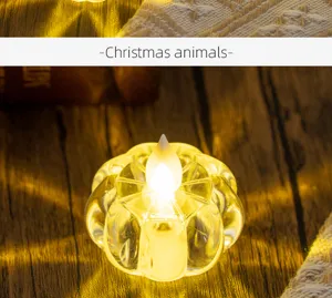 Close-up of a warm yellow pumpkin-shaped LED tea light on a rustic wooden table