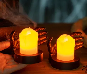 Detail view of Halloween skeleton hand LED candle lamp held in hand for scale.