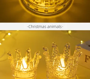 Close-up of crystal glass crown LED candle holder with warm yellow light and festive glow