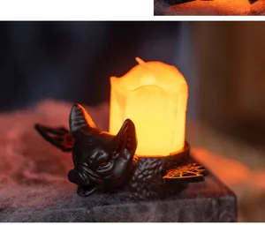 Close-up of a spooky Halloween bat candle holder featuring a flickering warm LED light