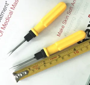 Detail shot of mini slotted screwdrivers with yellow handles and measuring tape for size.