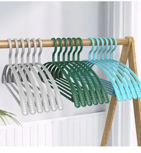 Detail view of plastic non-slip wide shoulder clothes hangers in grey green and blue.