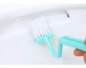 Detailed close-up shot of the V-shaped plastic toilet brush cleaning deep inside bowl corners.