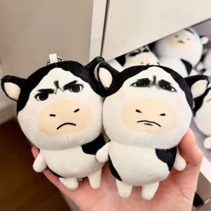 Cute funny cow plush toy keychain pendant with abstract expression and soft fluffy material.