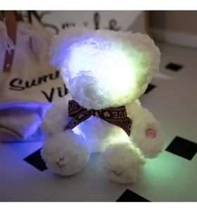 Glowing plush bear toy with light and sound effects, cute white stuffed animal for gift.