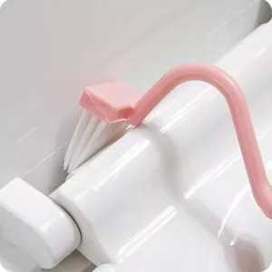 Pink long-handled curved toilet brush for deep cleaning bathroom gaps and toilet seat edges easily.