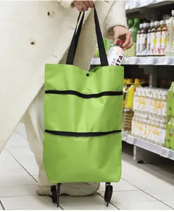 Detail view of foldable rolling shopping bag with wheels, portable grocery cart in use.