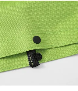 Detailed close-up of green woven shopping bag fabric featuring a black snap button fastener.