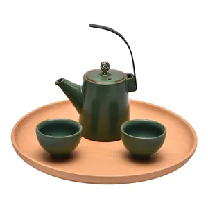 Minimalist ceramic tea set with wooden round tray, retro green teapot and cups for home daily use.