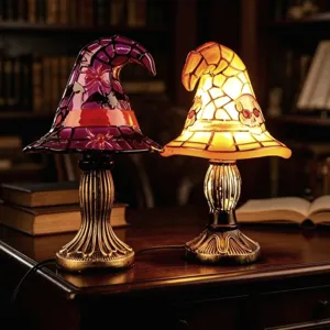 Detail view of two glowing Halloween witch hat lamps with skull and spider designs
