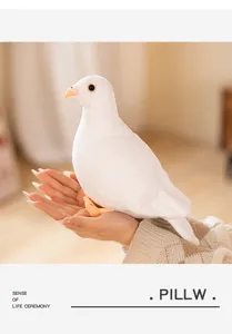 Close-up view of a realistic white plush pigeon toy held in hand, soft and cozy decor detail.