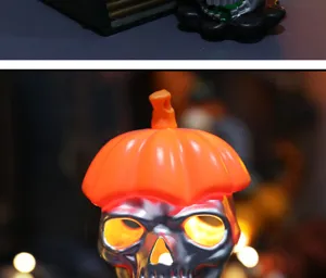 Detailed macro view of silver Halloween skull LED light with an orange pumpkin hat