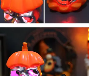 Detailed close-up of Halloween skull LED light with orange pumpkin hat and glowing eyes