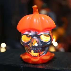Atmospheric Halloween silver skull LED candle light with glowing orange pumpkin cap