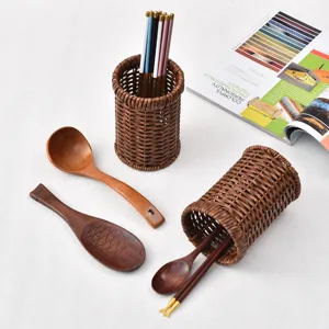 Rattan-style chopstick holder kitchen storage basket with wooden spoons and chopsticks set main view.