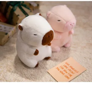 Detailed close-up shot of cute capybara plush toys set on cozy carpet with gift boxes.