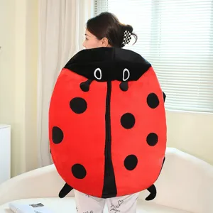 Detailed view of the cute ladybug plush costume and sofa pillow in cozy red and black design.