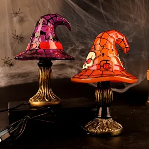 Atmospheric Halloween witch hat table lamps featuring spider and skull glass designs