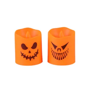 Two spooky orange Halloween LED candles with flickering pumpkin face designs for party