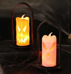 Halloween LED candle lanterns with pumpkin and skull faces on spooky web background