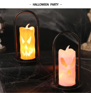 Close-up of Halloween LED candle lamps with pumpkin and skull faces in a spooky horror setting