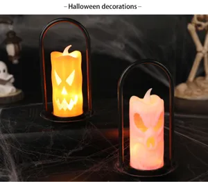 Close-up of Halloween LED candle lanterns with pumpkin and skull faces glowing in dark