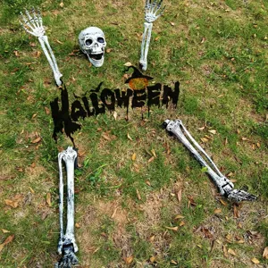 Detailed view of Halloween plastic skeleton ground stakes in a natural grassy yard setting.